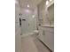 Modern bathroom featuring a glass shower, white subway tile, and vanity with stone countertop at 26017 Seastone Dr, Englewood, FL 34223
