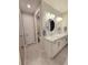Bathroom featuring double sinks with modern lighting, and a toilet in a separate room at 26017 Seastone Dr, Englewood, FL 34223