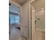 View of a bedroom and bathroom with an open door showcasing a white tiled shower at 26017 Seastone Dr, Englewood, FL 34223