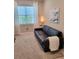 Bedroom or office featuring a couch, carpeted floor, and bright natural light at 26017 Seastone Dr, Englewood, FL 34223