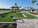 Resort-style community area with beautiful landscaping, pool and cornhole for outdoor games and enjoyment at 26017 Seastone Dr, Englewood, FL 34223