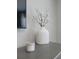 Modern decor featuring a white ceramic vase with decorative flowering branches and a scented candle at 26017 Seastone Dr, Englewood, FL 34223