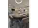 Dining area with seating for six, open to the kitchen and living areas, and modern lighting at 26017 Seastone Dr, Englewood, FL 34223