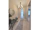 Elegant foyer with chandelier, decorative mirror, console table, and a view into the home's interior at 26017 Seastone Dr, Englewood, FL 34223