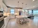 Spacious kitchen with an island and bar stool seating, stainless steel appliances, and white cabinetry at 26017 Seastone Dr, Englewood, FL 34223