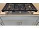 Modern KitchenAid cooktop with five burners set in a light countertop at 26017 Seastone Dr, Englewood, FL 34223