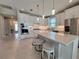 Open kitchen with a large island, white cabinets, stainless steel appliances, and pendant lighting at 26017 Seastone Dr, Englewood, FL 34223