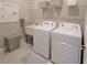 Laundry room featuring a washer, dryer, utility sink and wire shelving at 26017 Seastone Dr, Englewood, FL 34223