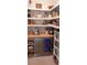 Organized pantry with wooden countertops, open shelving, wine fridge, and a variety of storage solutions at 26017 Seastone Dr, Englewood, FL 34223