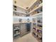 Walk-in pantry features built-in shelving, a beverage refrigerator, and a countertop workspace at 26017 Seastone Dr, Englewood, FL 34223