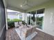 Relaxing screened patio with comfortable seating and views of the well-manicured backyard at 26017 Seastone Dr, Englewood, FL 34223