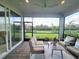 Enjoy the serene screened patio featuring plush seating and a tranquil view of the lush lawn at 26017 Seastone Dr, Englewood, FL 34223