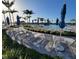 Inviting outdoor lounging area with comfortable seating, umbrellas, and picturesque pool views at 26017 Seastone Dr, Englewood, FL 34223