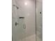 Close up of a shower featuring a glass door, subway tile, and modern shower head at 26017 Seastone Dr, Englewood, FL 34223