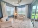 Inviting sunroom with natural light, comfortable seating, and access to the outdoors at 26017 Seastone Dr, Englewood, FL 34223