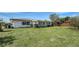 Backyard view showing the home's enclosed back porch and spacious lawn at 2702 Bedford Way, Sarasota, FL 34239