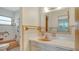 A vintage bathroom featuring peach colored fixtures, white tile, and a shower/tub combo at 2702 Bedford Way, Sarasota, FL 34239