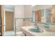Vintage bathroom features blue and white tiling, a sink with storage, and ample lighting at 2702 Bedford Way, Sarasota, FL 34239