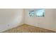 Simple bedroom with a window providing natural light and neutral carpet at 2702 Bedford Way, Sarasota, FL 34239