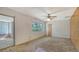 Bedroom with ceiling fan, window, and sliding door access to the sunroom at 2702 Bedford Way, Sarasota, FL 34239