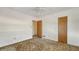 Neutral bedroom featuring brown carpet, a ceiling fan, and two wooden doors at 2702 Bedford Way, Sarasota, FL 34239