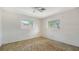 Bedroom with two windows providing plenty of natural light and neutral carpet at 2702 Bedford Way, Sarasota, FL 34239