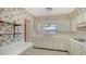 Vintage kitchen with unique wallpaper and bright sink, offering a nostalgic charm at 2702 Bedford Way, Sarasota, FL 34239