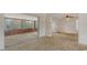 Bright and airy living room featuring classic carpet and smooth transition to sunroom at 2702 Bedford Way, Sarasota, FL 34239
