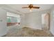 Comfortable room with ceiling fan and access to the sunroom, perfect for relaxing at 2702 Bedford Way, Sarasota, FL 34239