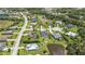 Wide aerial view of a residential neighborhood with lush green lawns, mature trees, and tranquil ponds at 3015 160Th E Ter, Parrish, FL 34219