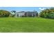 Expansive backyard with lush green grass and a screened-in lanai, ideal for outdoor enjoyment at 3015 160Th E Ter, Parrish, FL 34219