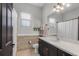 Bright bathroom with a single sink vanity, linen closet, and tiled floors at 3015 160Th E Ter, Parrish, FL 34219
