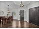 Elegant dining room with a wooden table, pendant lighting, and a view of the front entrance at 3015 160Th E Ter, Parrish, FL 34219