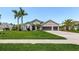 Charming single-Gathering home with manicured lawn, mature palm trees, and a three-car garage at 3015 160Th E Ter, Parrish, FL 34219
