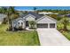 Charming single-Gathering home with a well-manicured lawn, mature trees, and a three-car garage at 3015 160Th E Ter, Parrish, FL 34219
