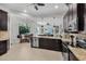 Modern kitchen with a breakfast nook, stainless steel appliances, and dark wood cabinets at 3015 160Th E Ter, Parrish, FL 34219