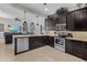 Open-concept kitchen with dark wood cabinets and stainless steel appliances at 3015 160Th E Ter, Parrish, FL 34219