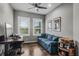 Comfortable living room featuring a stylish blue couch, modern ceiling fan, and wood-look flooring at 3015 160Th E Ter, Parrish, FL 34219