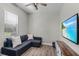 Simple living room featuring a modern sectional sofa, TV, and bright natural light at 3015 160Th E Ter, Parrish, FL 34219