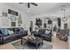 Cozy living room with leather sofas, decorative wall art, and an open layout to the kitchen at 3015 160Th E Ter, Parrish, FL 34219