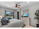 Comfortable main bedroom featuring a ceiling fan and sliding glass doors leading to a pool area at 3015 160Th E Ter, Parrish, FL 34219