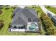 Overhead angle of a home with screened in pool and outdoor seating area with grill and chairs at 3015 160Th E Ter, Parrish, FL 34219