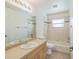 Bathroom featuring a vanity, a toilet, a bath tub and shower, and light-colored tile at 3204 Pericles Ave, North Port, FL 34286