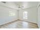 Bedroom featuring a ceiling fan, wood-look flooring, two windows, a closet, and neutral walls at 3204 Pericles Ave, North Port, FL 34286