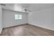 Cozy bedroom with wood-look flooring, a ceiling fan, a window, and neutral-colored walls at 3204 Pericles Ave, North Port, FL 34286