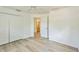 Bedroom featuring wood-look flooring, and a closet, with the bathroom visible through the doorway at 3204 Pericles Ave, North Port, FL 34286