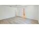 Bright bedroom with wood-look flooring, showing the bathroom through the doorway at 3204 Pericles Ave, North Port, FL 34286