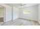 Bright bedroom with a ceiling fan, wood-look flooring, a closet, a window, and neutral walls at 3204 Pericles Ave, North Port, FL 34286