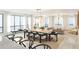Elegant dining area with a large table, modern chairs, and views of the living space and water beyond at 33 S Palm Ave # 1501, Sarasota, FL 34236