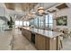 A kitchenette with a large island, pendant lights, and access to outdoor views at 33 S Palm Ave # 1501, Sarasota, FL 34236